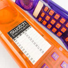 Cargar imagen en el visor de la galería, Teléfono Swatch Twinphone morado y naranja, 1989.